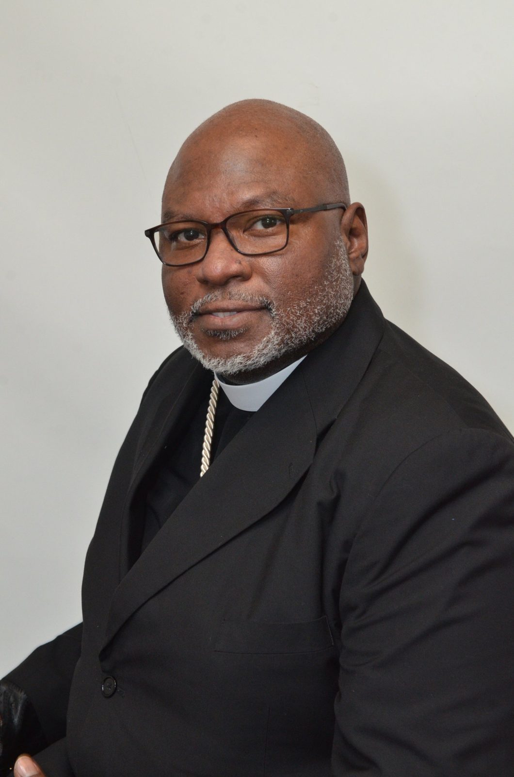 Church In Order consultant in clerical collar and dark suit