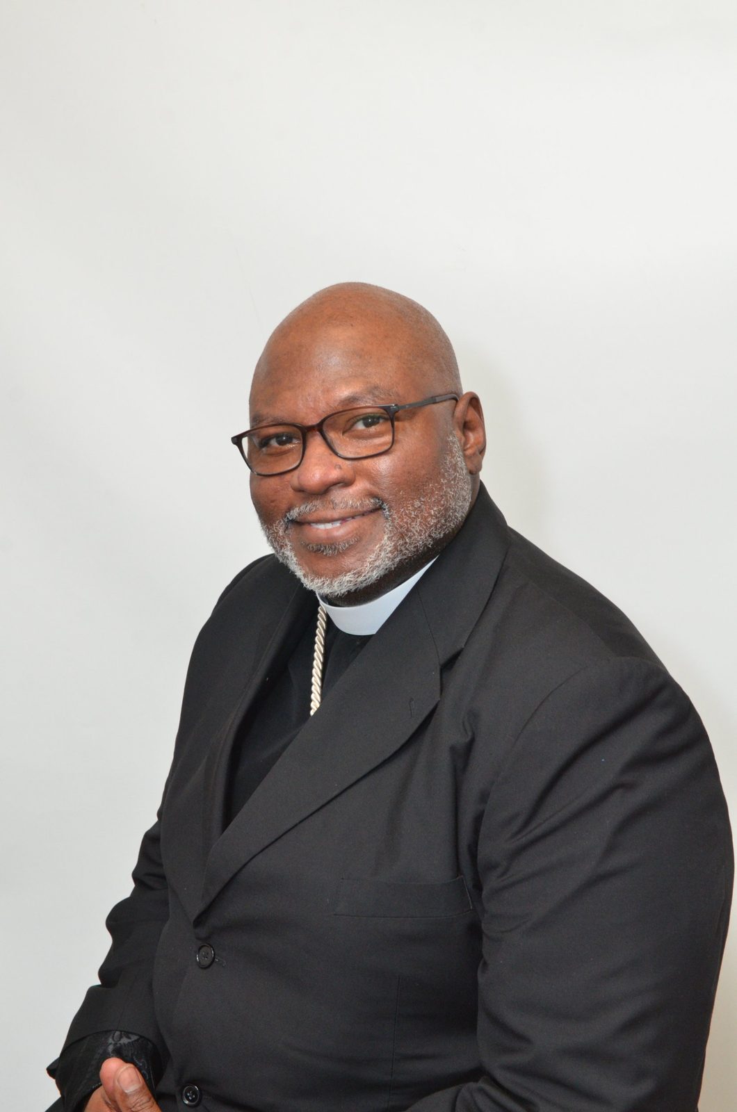 Church In Order consultant in clerical collar and dark suit