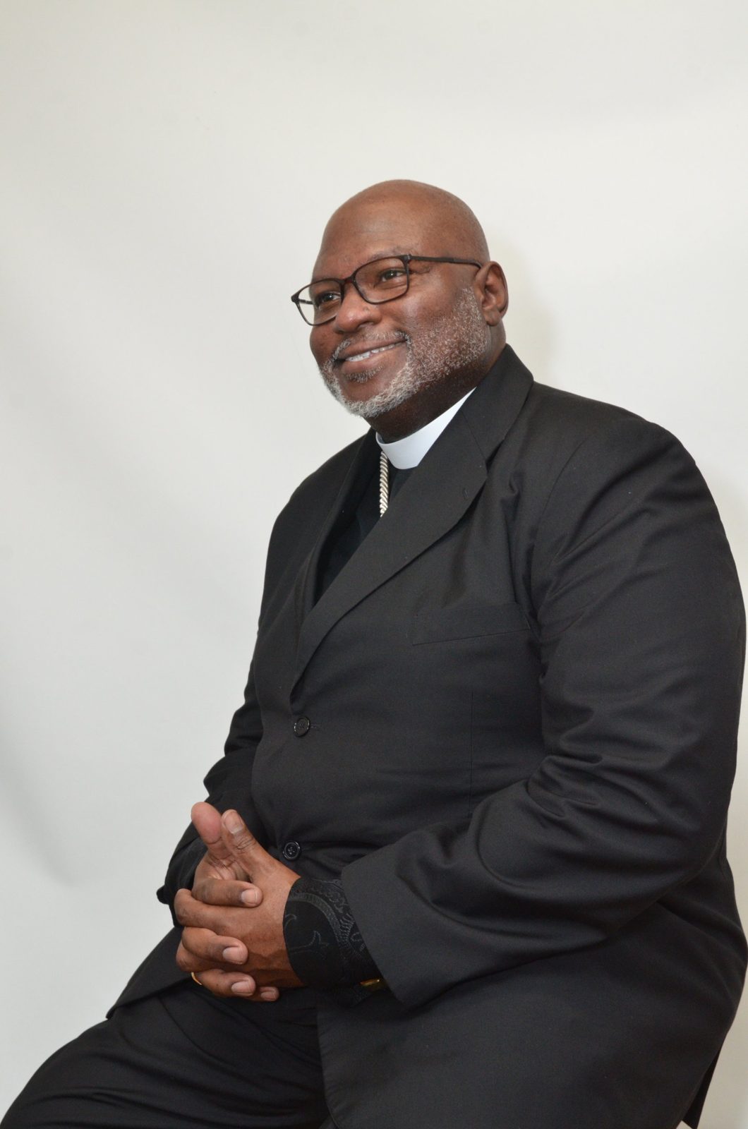 Church In Order consultant in clerical collar and dark suit